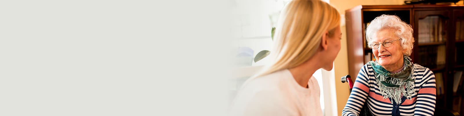 A woman sitting with an elderly woman